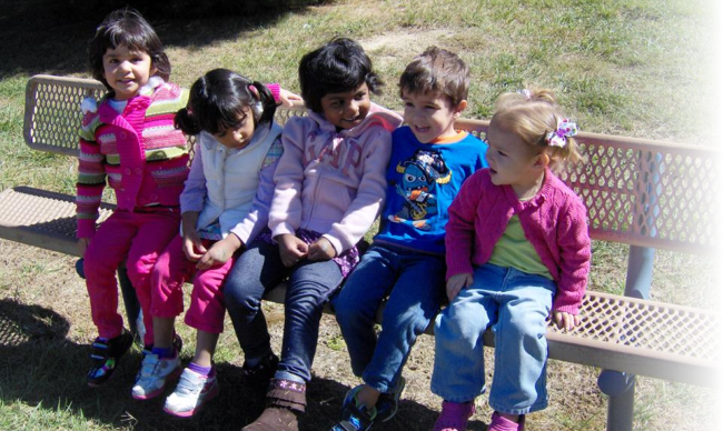 kids happily seating in the bench