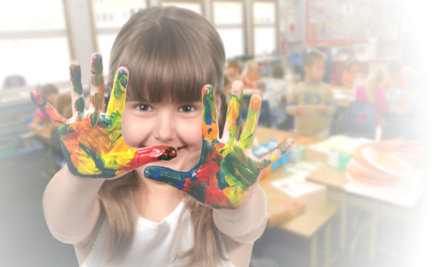 little girl playing with paints